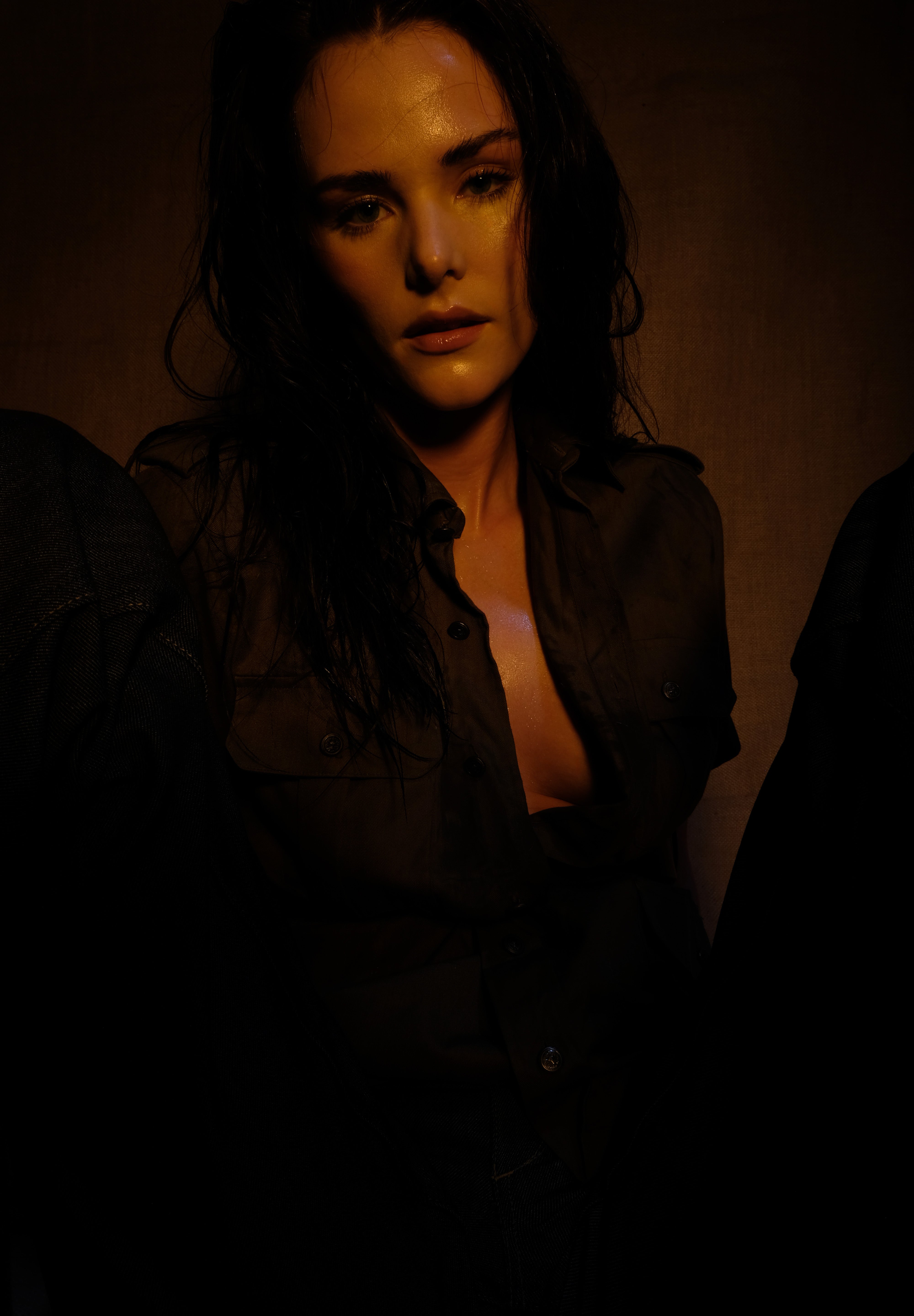 woman sitting in safari shirt and raw denim jeans 